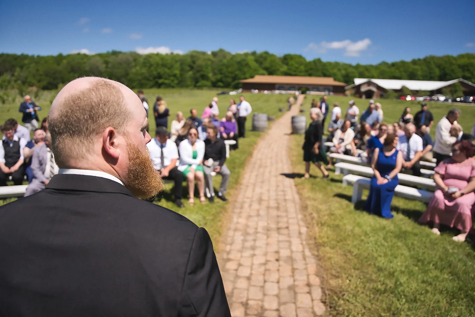 mother and flower girl candid moment at ceremony, seated guests