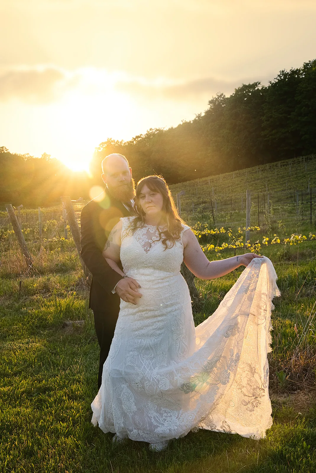 bride and groom portrait holding hands in vineyard at golden hour