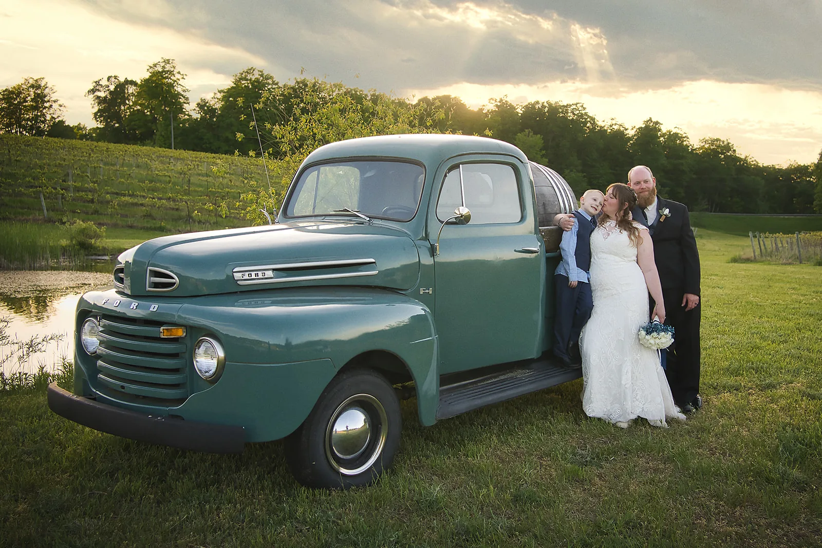 bride and groom close kiss portrait in vineyard, golden light