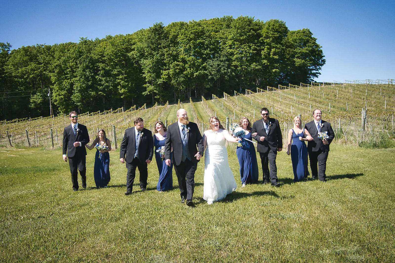 groom embracing bride by reception table, candlelight