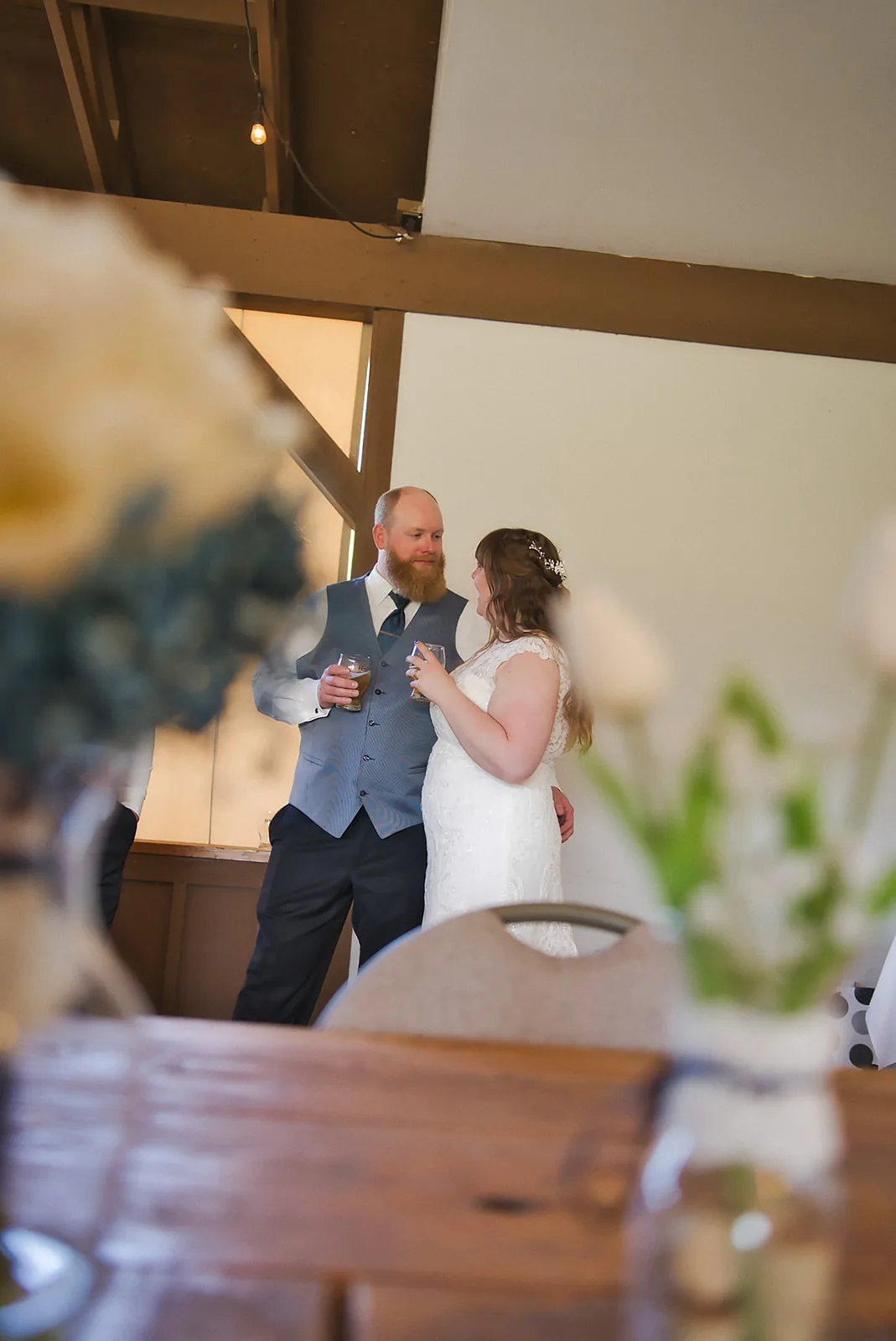 bride and groom first dance at reception, guests seated around