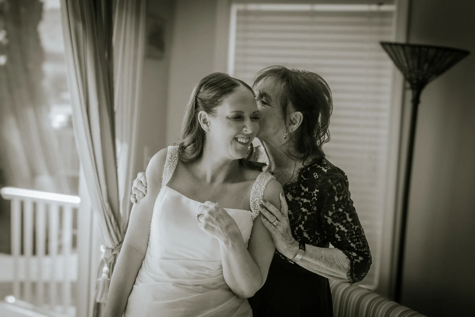 bw bride and mother embracing, foreheads together, getting ready