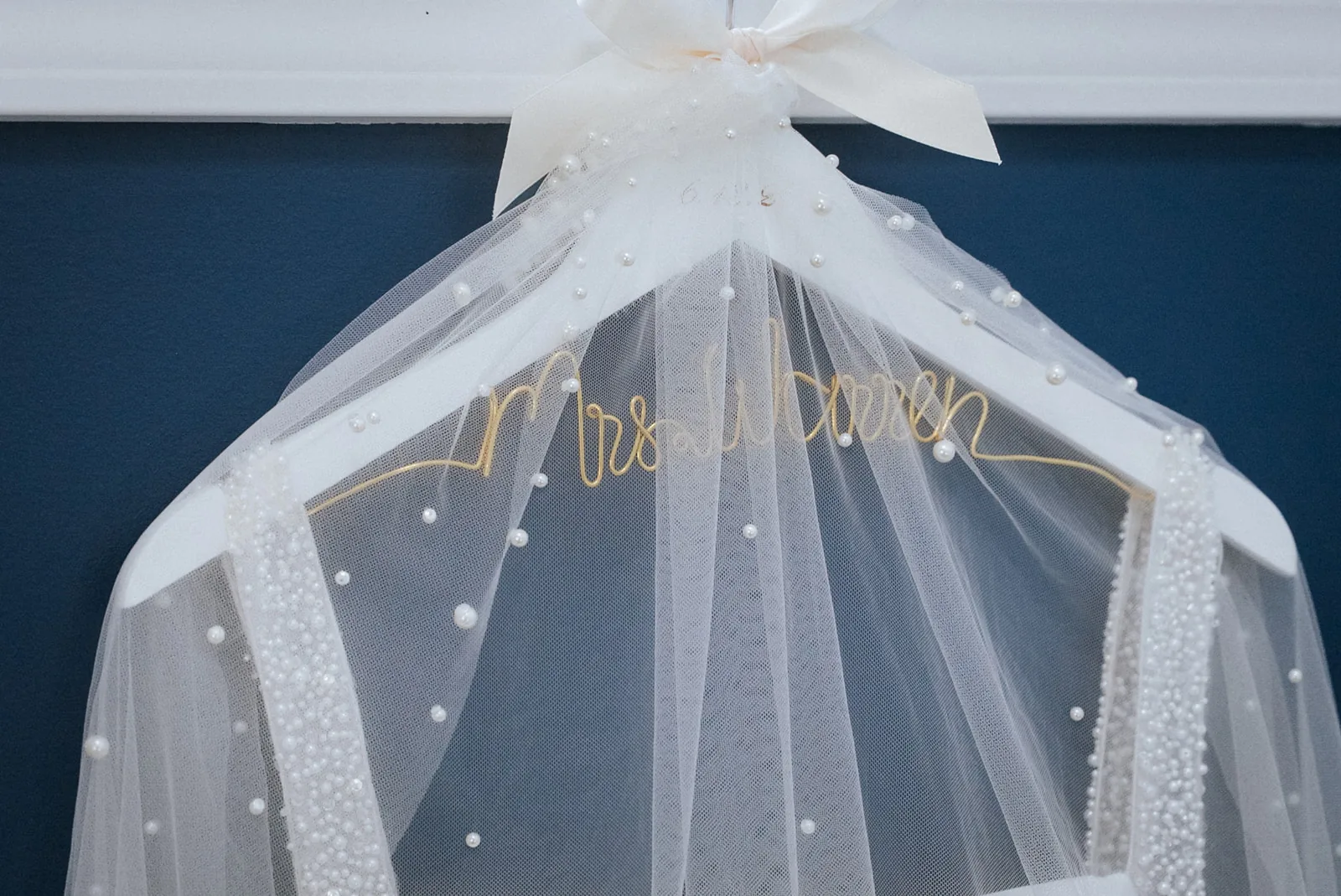 detail of veil hanging with "Mrs Warren" embroidered ribbon