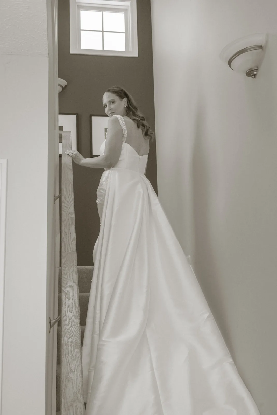 bride walking up staircase in wedding dress, getting ready
