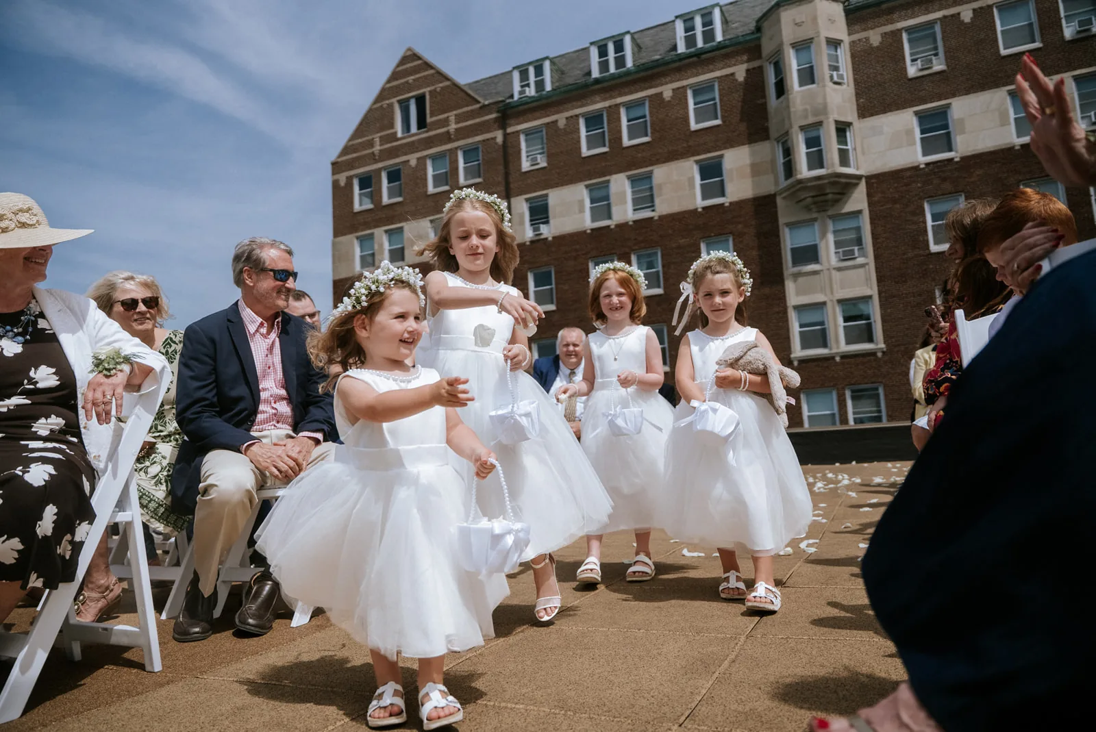 flower girls walking down aisle, rooftop venue, close-up