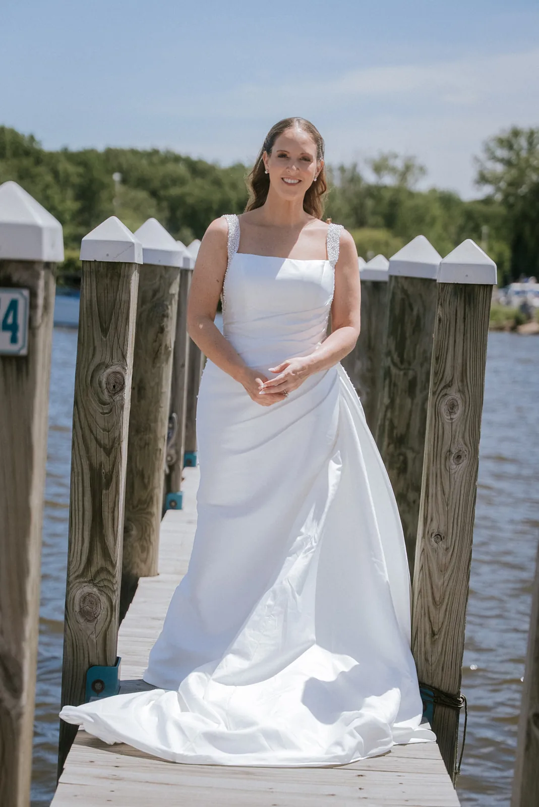 bride solo portrait on dock, looking at camera, lake view