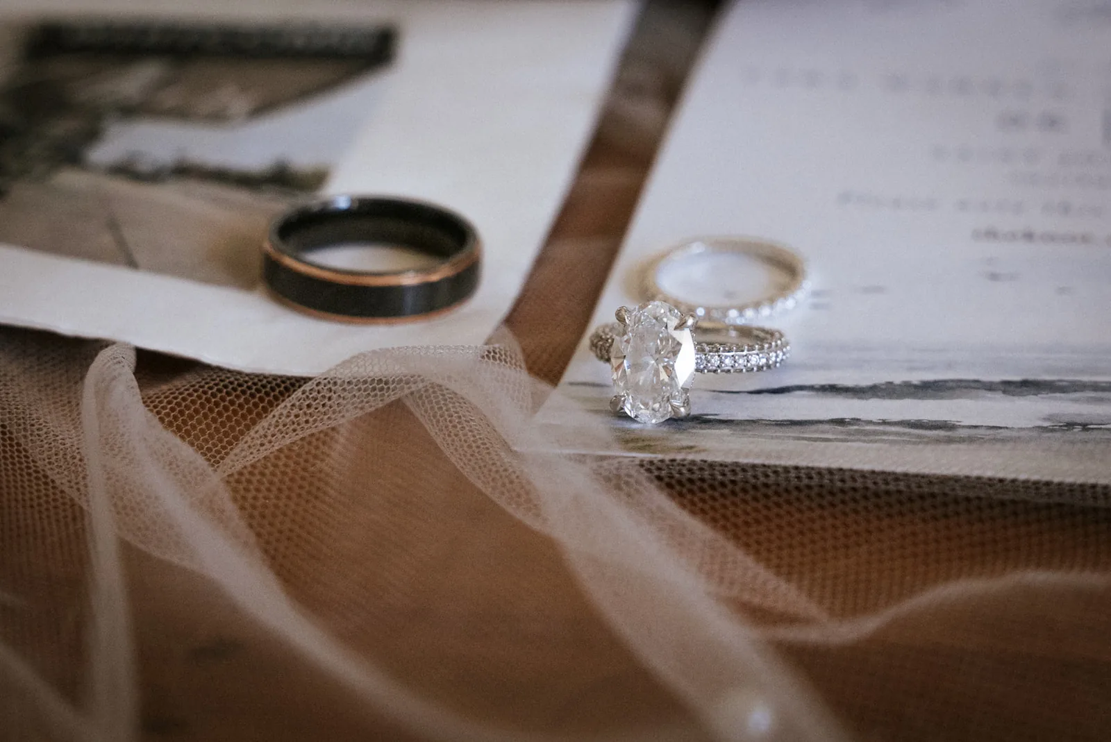 macro detail of wedding rings on invitation suite