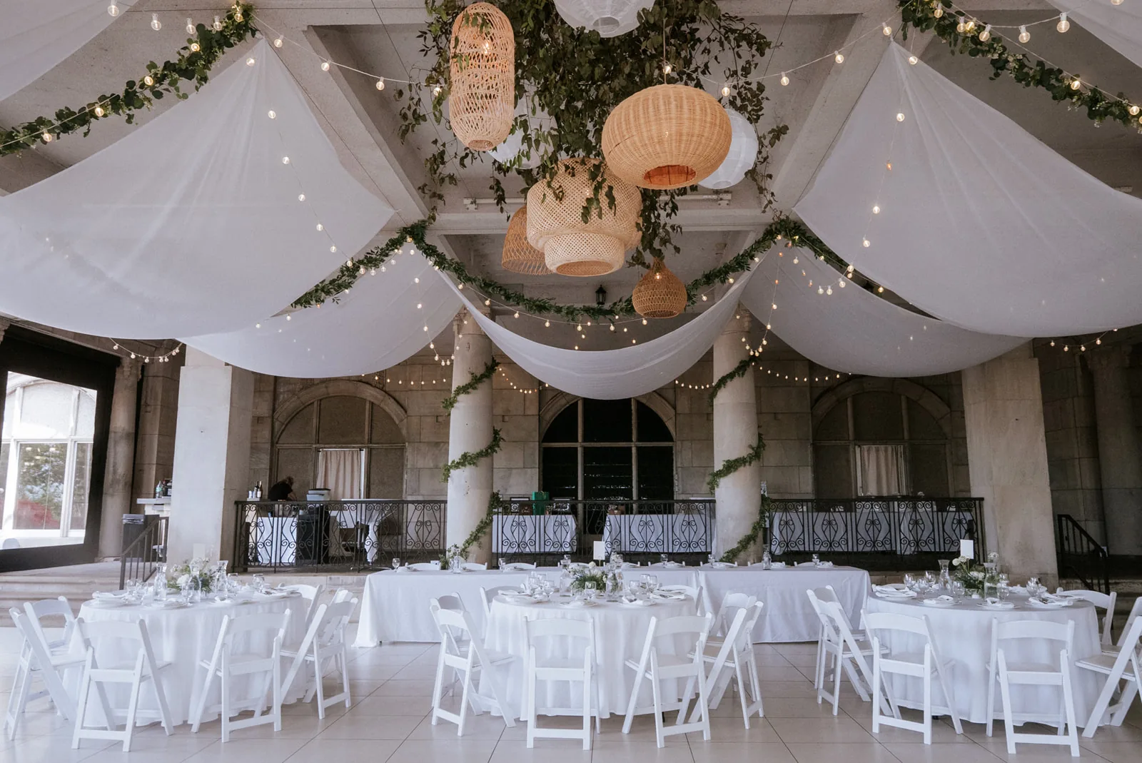 wide shot reception room with draped tent ceiling and lanterns