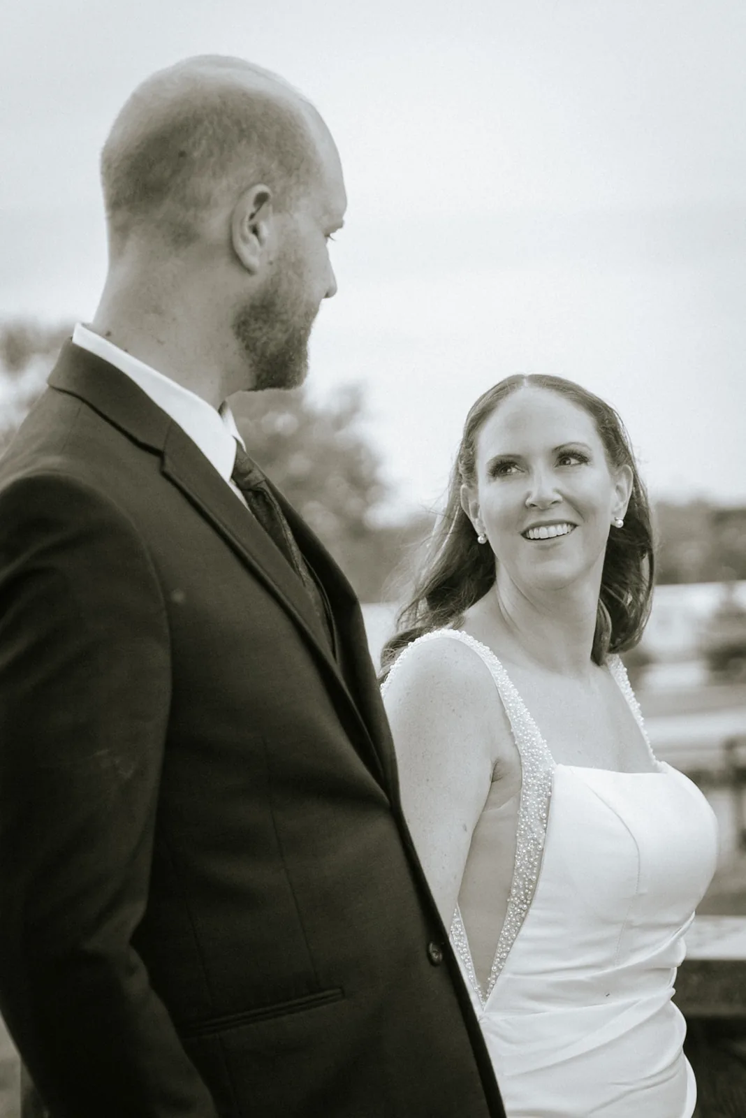 bw groom profile portrait, looking toward bride