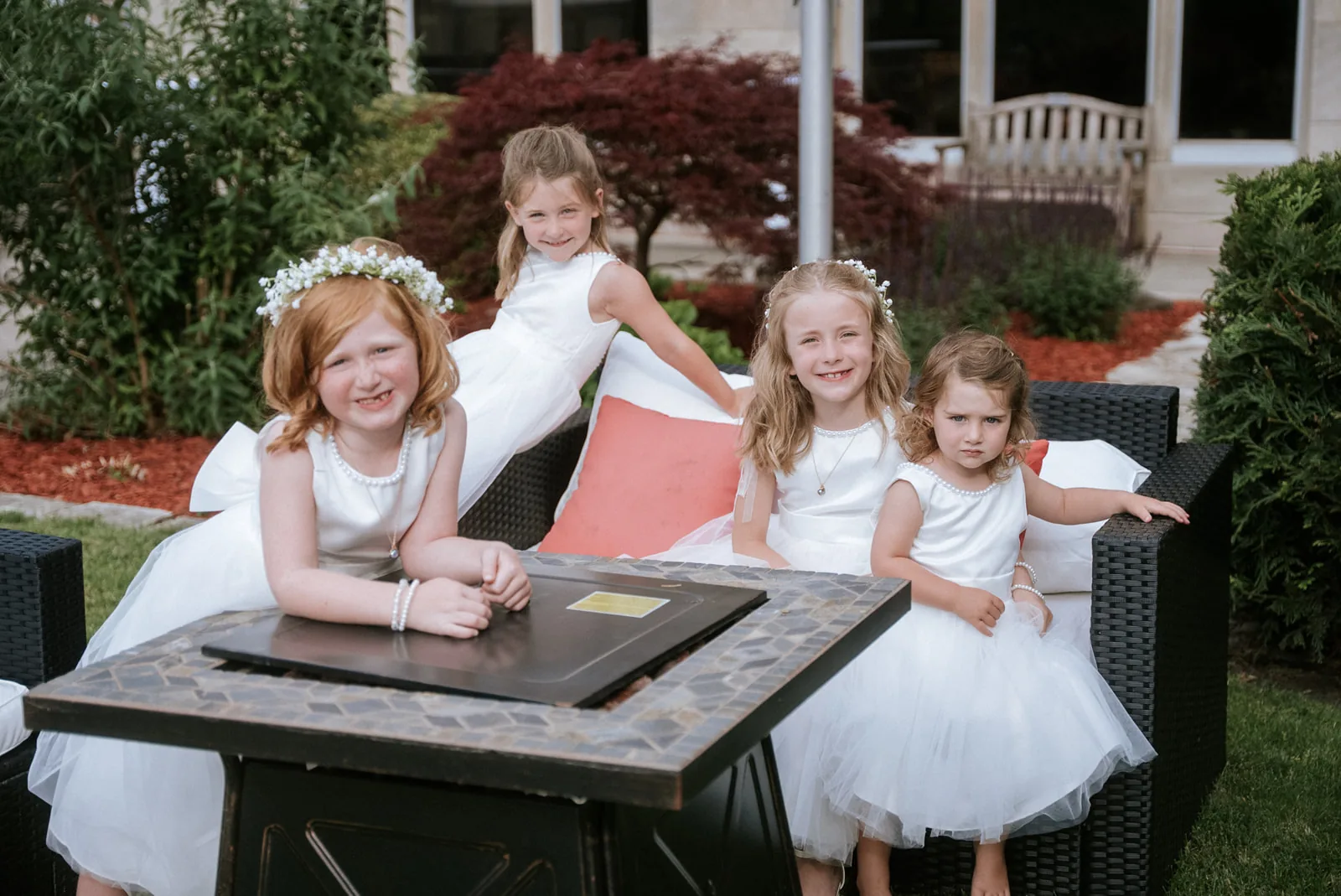 flower girls group portrait seated on outdoor furniture
