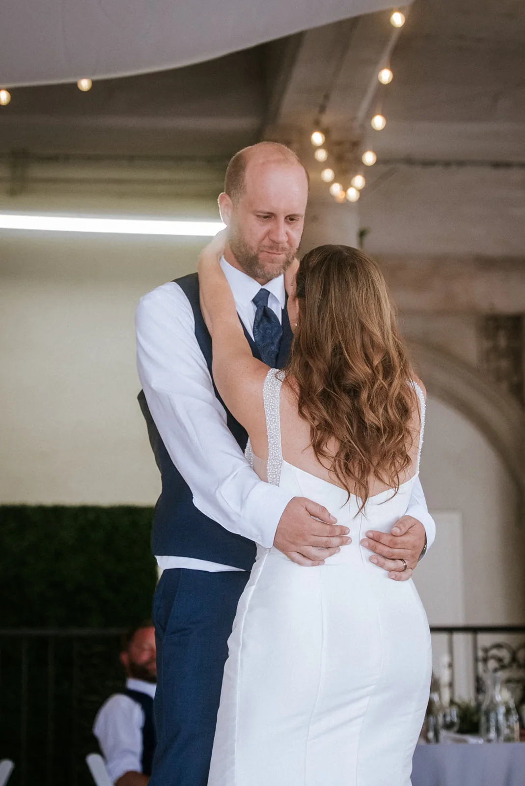 bride and groom first dance, close embrace, reception