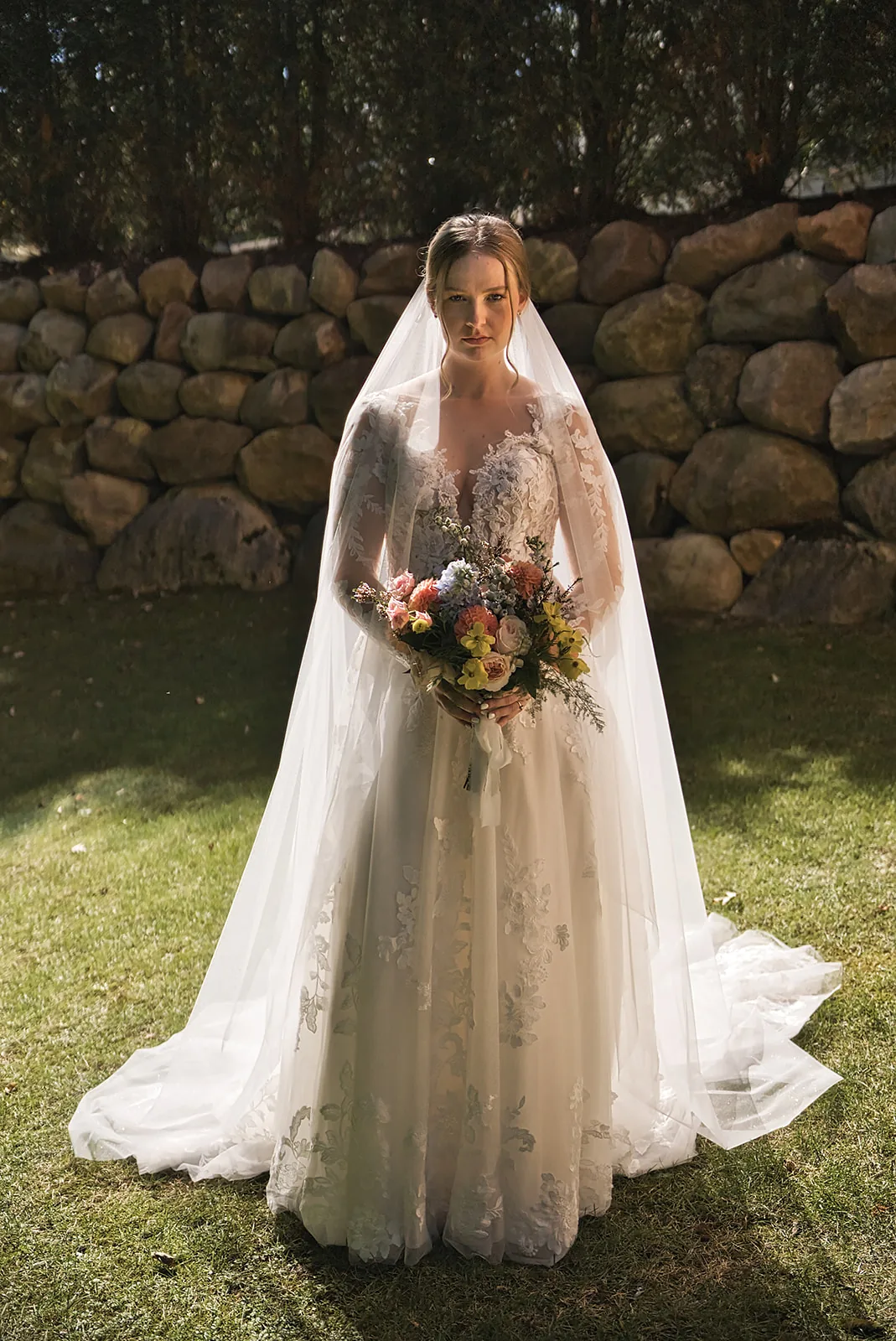 bridesmaid helping hang wedding dress on porch railing, getting ready
