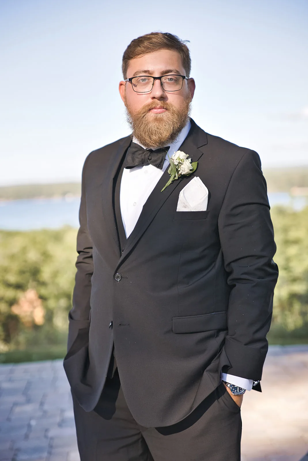 groom solo portrait, lake view, boutonniere, bow tie