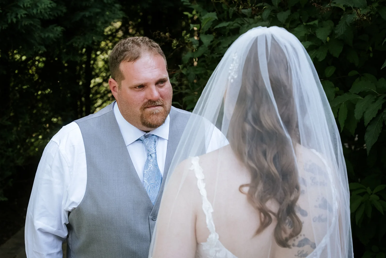 bride and groom face to face at first look, stone staircase