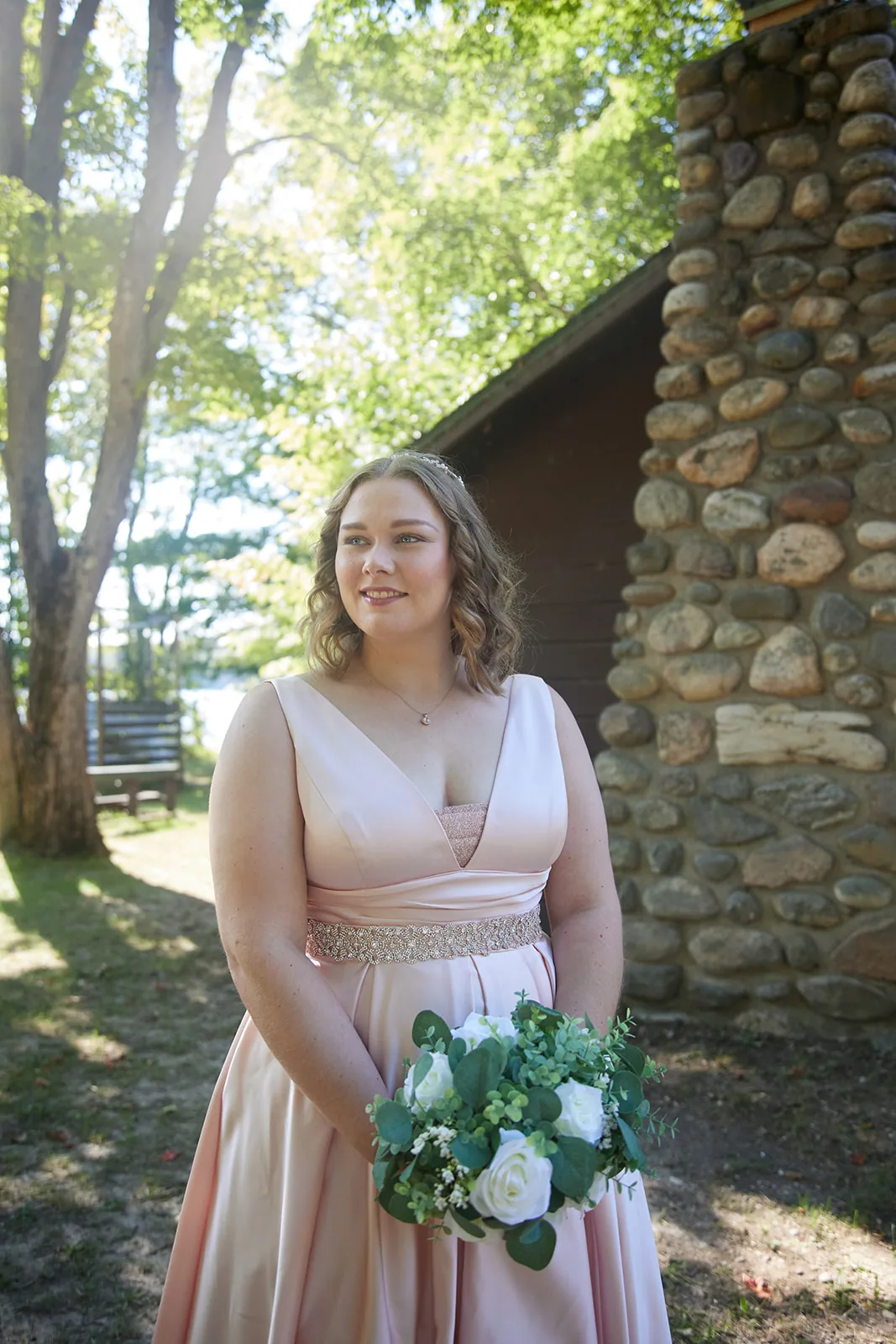 bride solo portrait under trees, lake visible behind