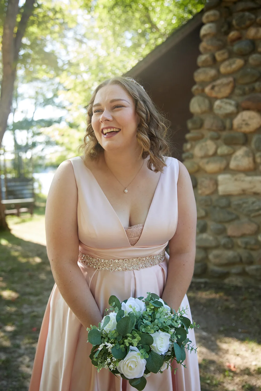 bride solo portrait laughing, stone chimney backdrop