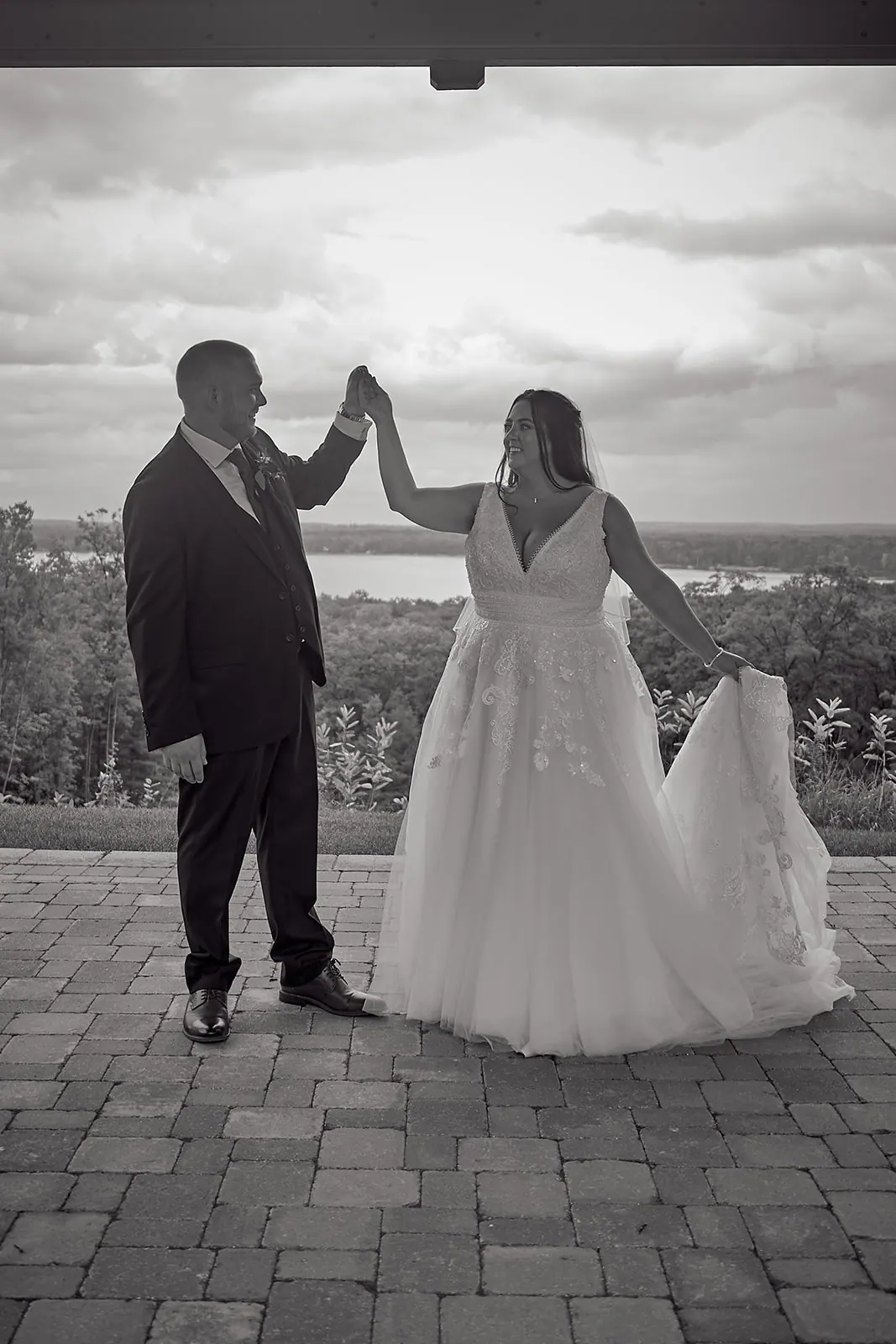 Black white couple holding hands patio — Taylor & Mark's wedding at The Manor at Fire Tower Hill, Lewiston, MI
