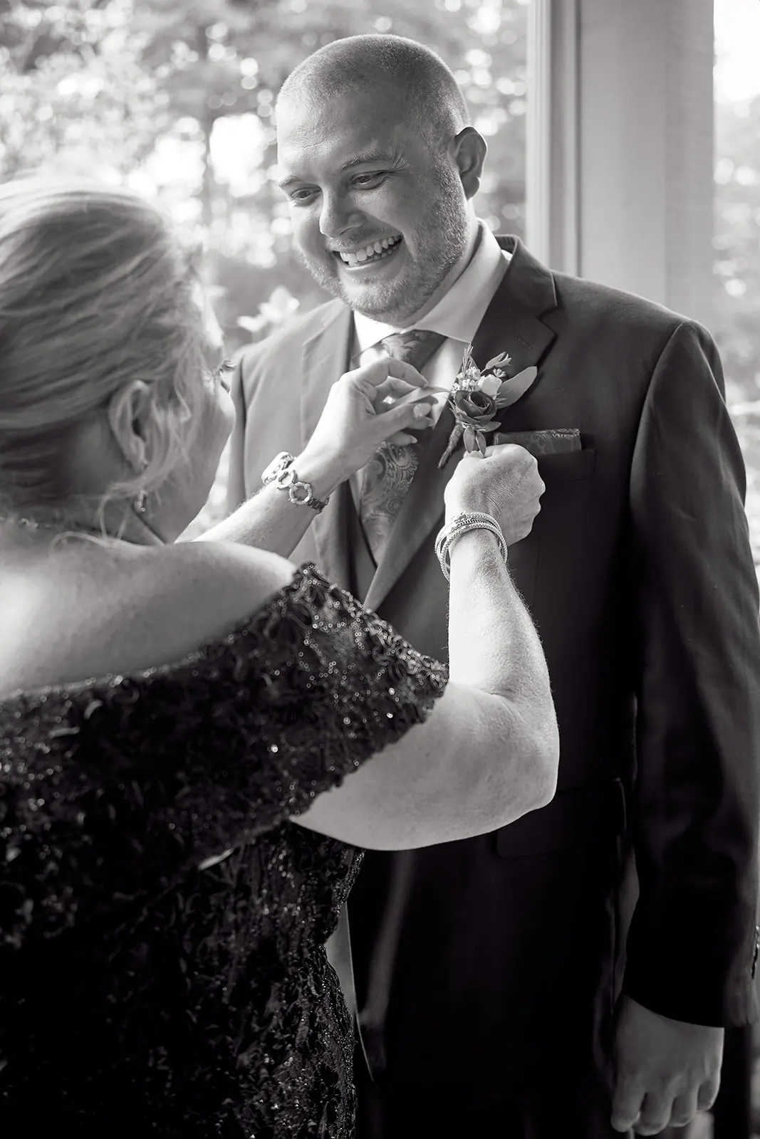 Black white mother adjusting groom s — Taylor & Mark's wedding at The Manor at Fire Tower Hill, Lewiston, MI