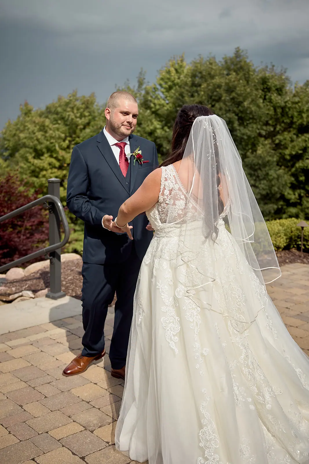 Bride groom standing patio bride looking — Taylor & Mark's wedding at The Manor at Fire Tower Hill, Lewiston, MI