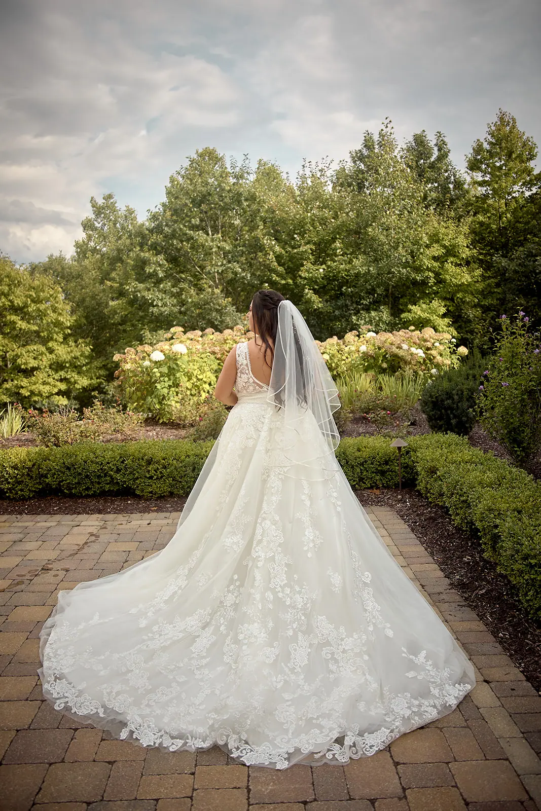 Bride lace gown veil seen walking — Taylor & Mark's wedding at The Manor at Fire Tower Hill, Lewiston, MI