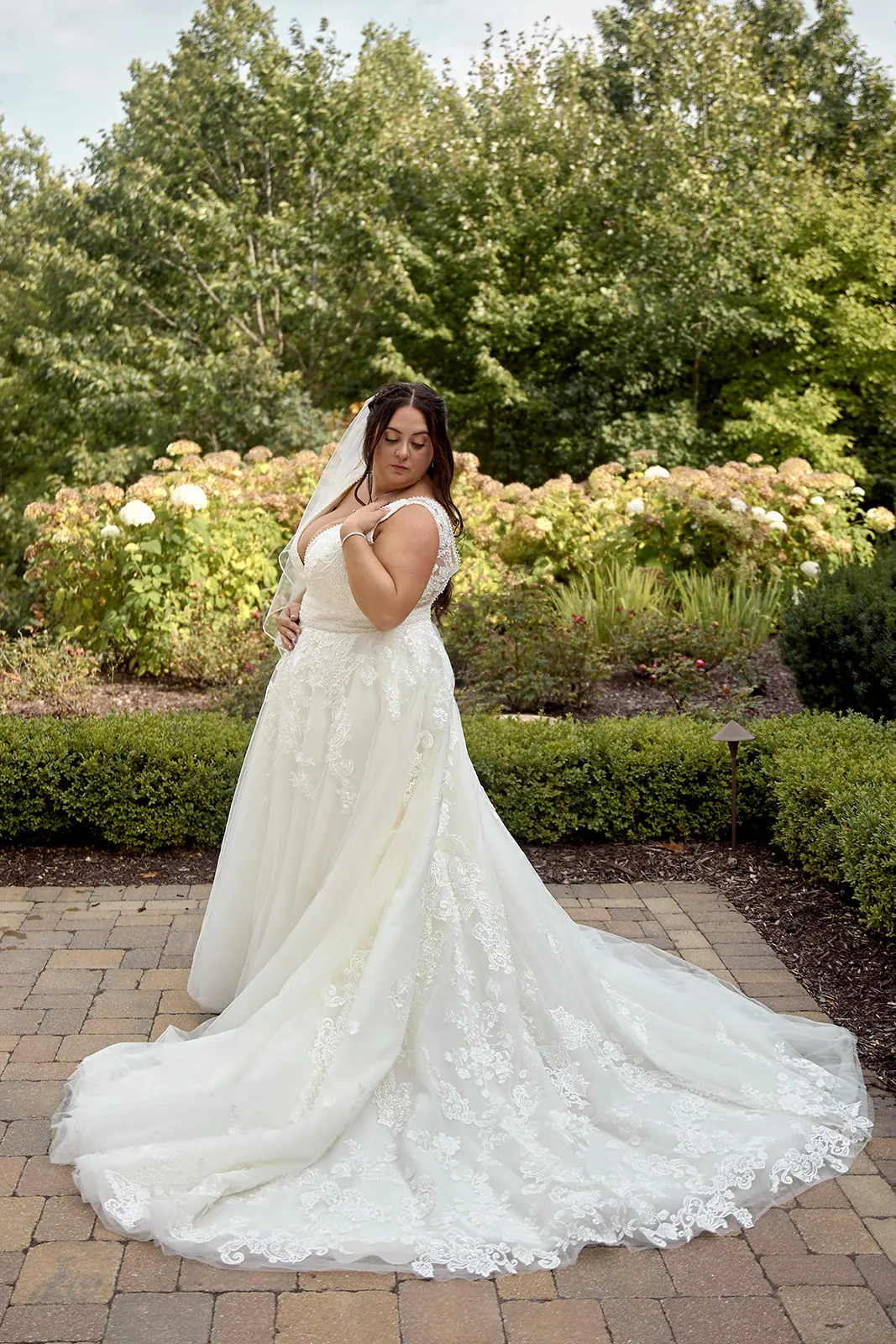 Bride long lace train garden path — Taylor & Mark's wedding at The Manor at Fire Tower Hill, Lewiston, MI
