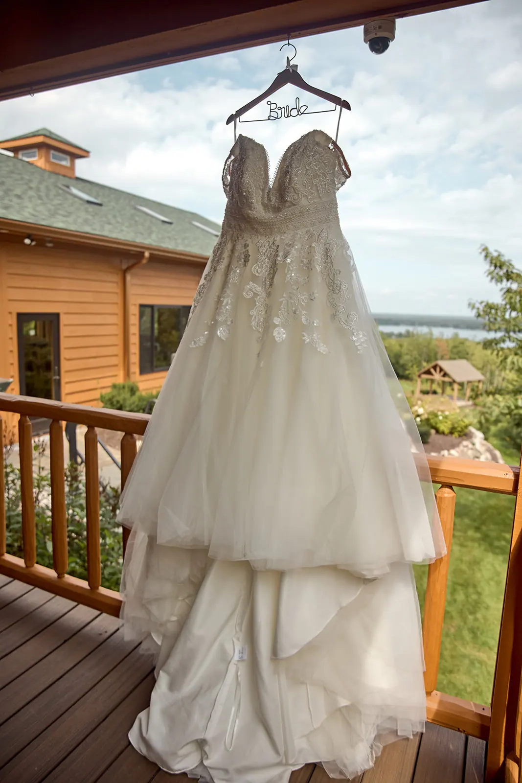 Bride s gown hanging railing lodge — Taylor & Mark's wedding at The Manor at Fire Tower Hill, Lewiston, MI