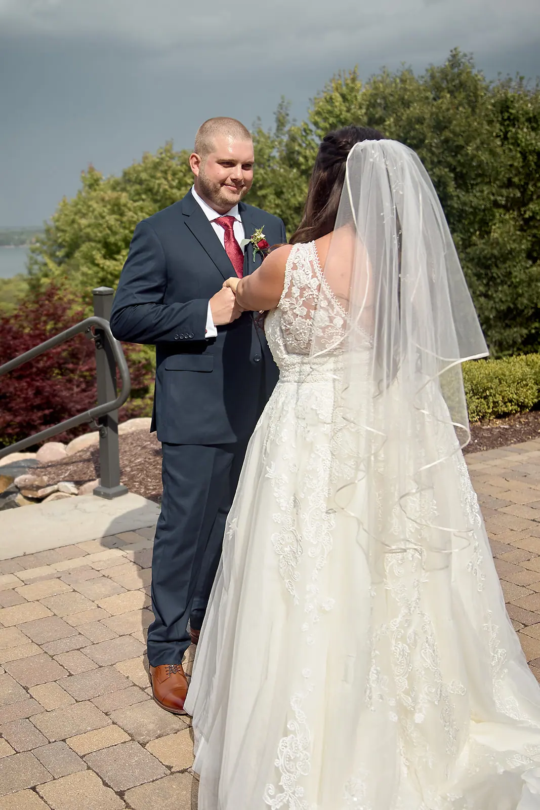 Bride veil groom adjusting tie patio — Taylor & Mark's wedding at The Manor at Fire Tower Hill, Lewiston, MI