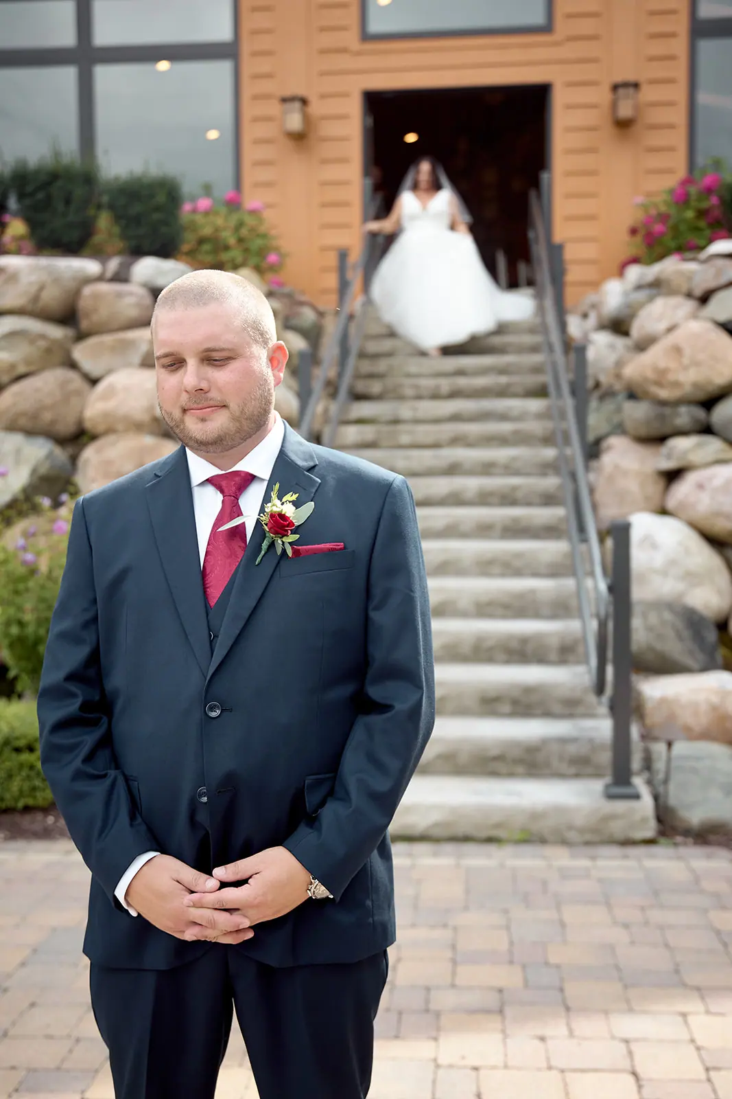 Bride walking stone steps groom waits — Taylor & Mark's wedding at The Manor at Fire Tower Hill, Lewiston, MI