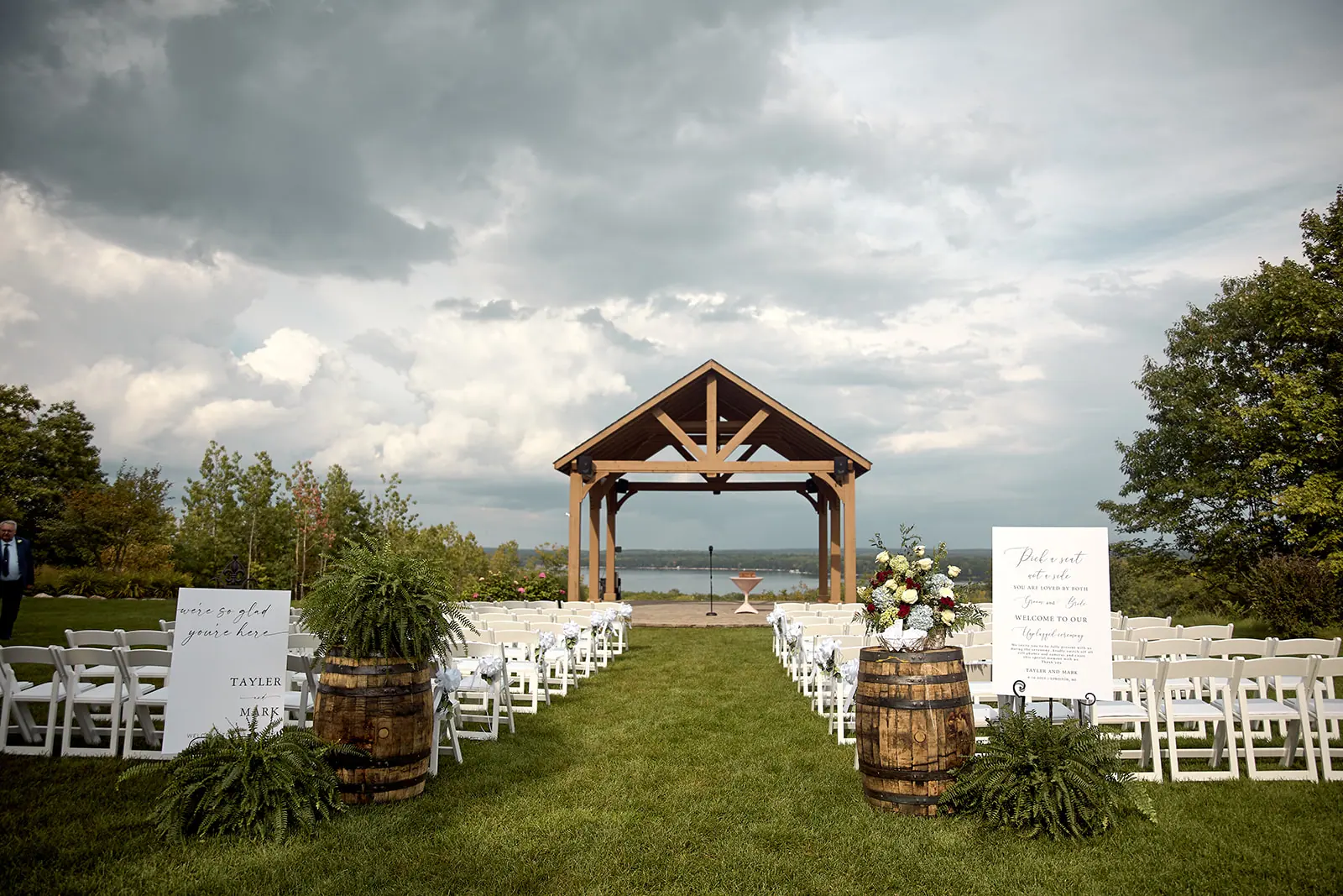 Ceremony set pavilion white chairs lake — Taylor & Mark's wedding at The Manor at Fire Tower Hill, Lewiston, MI