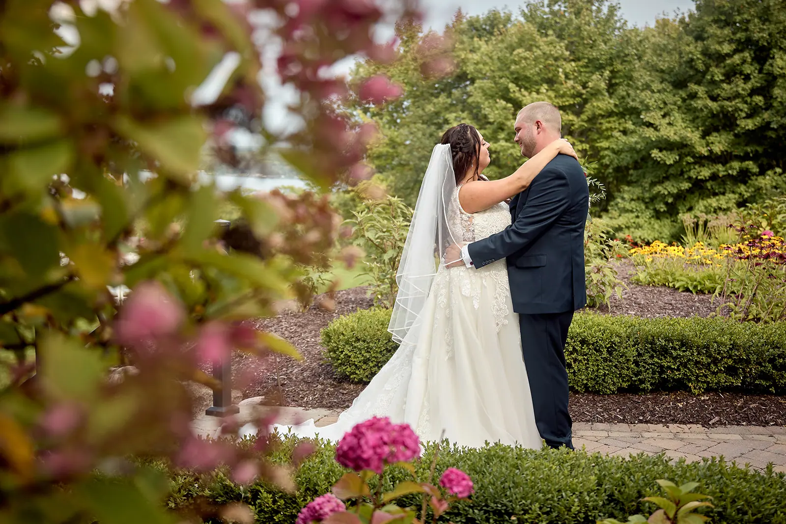 Couple dancing garden pink blossom foreground — Taylor & Mark's wedding at The Manor at Fire Tower Hill, Lewiston, MI