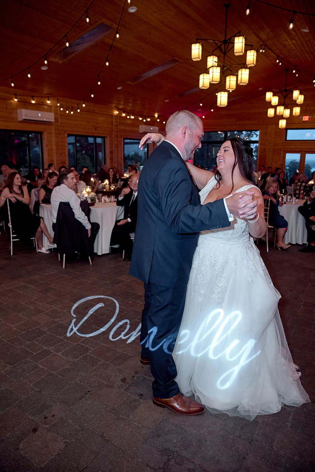 Couple dancing projected name floor — Taylor & Mark's wedding at The Manor at Fire Tower Hill, Lewiston, MI