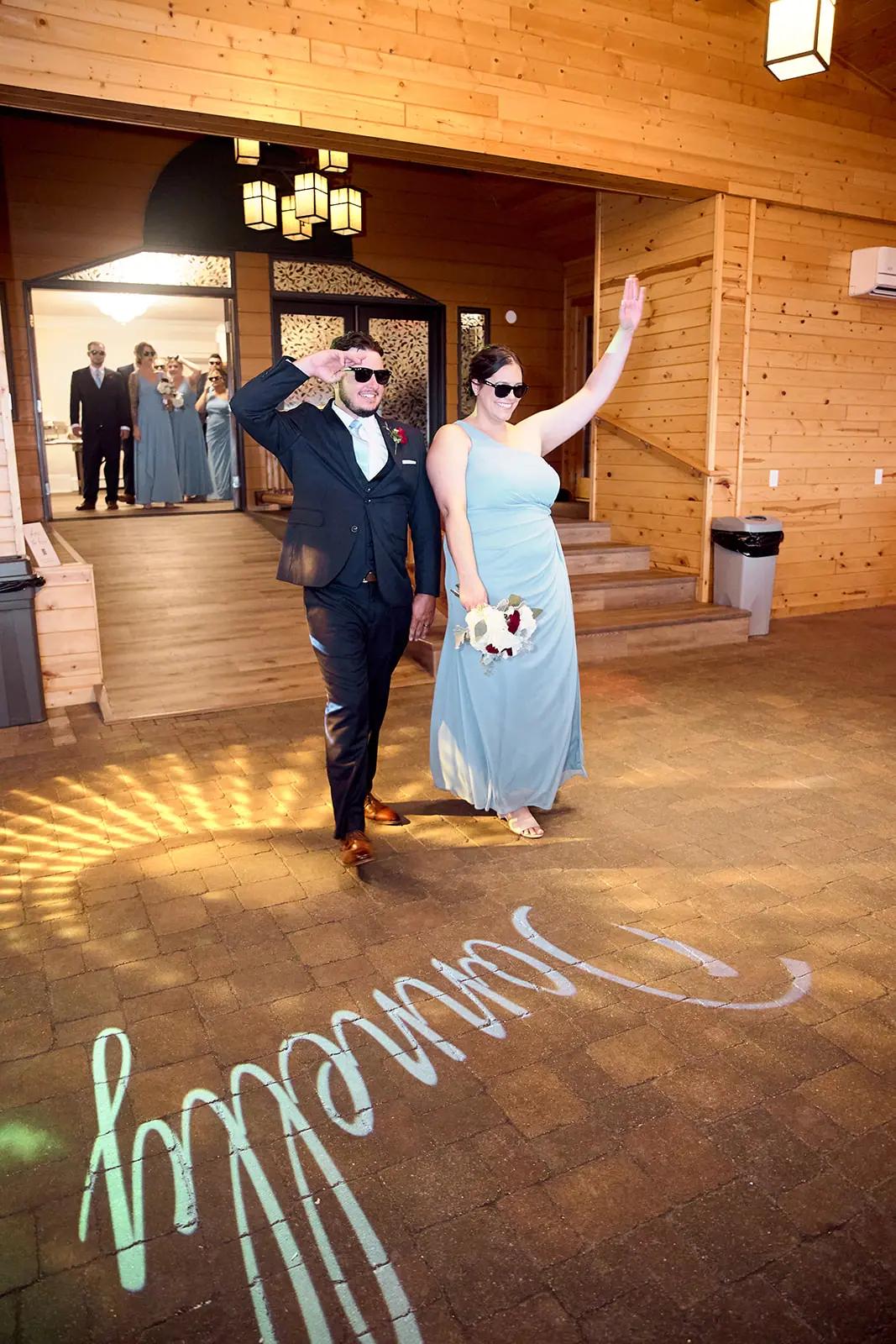 Couple entering reception hall projected name — Taylor & Mark's wedding at The Manor at Fire Tower Hill, Lewiston, MI