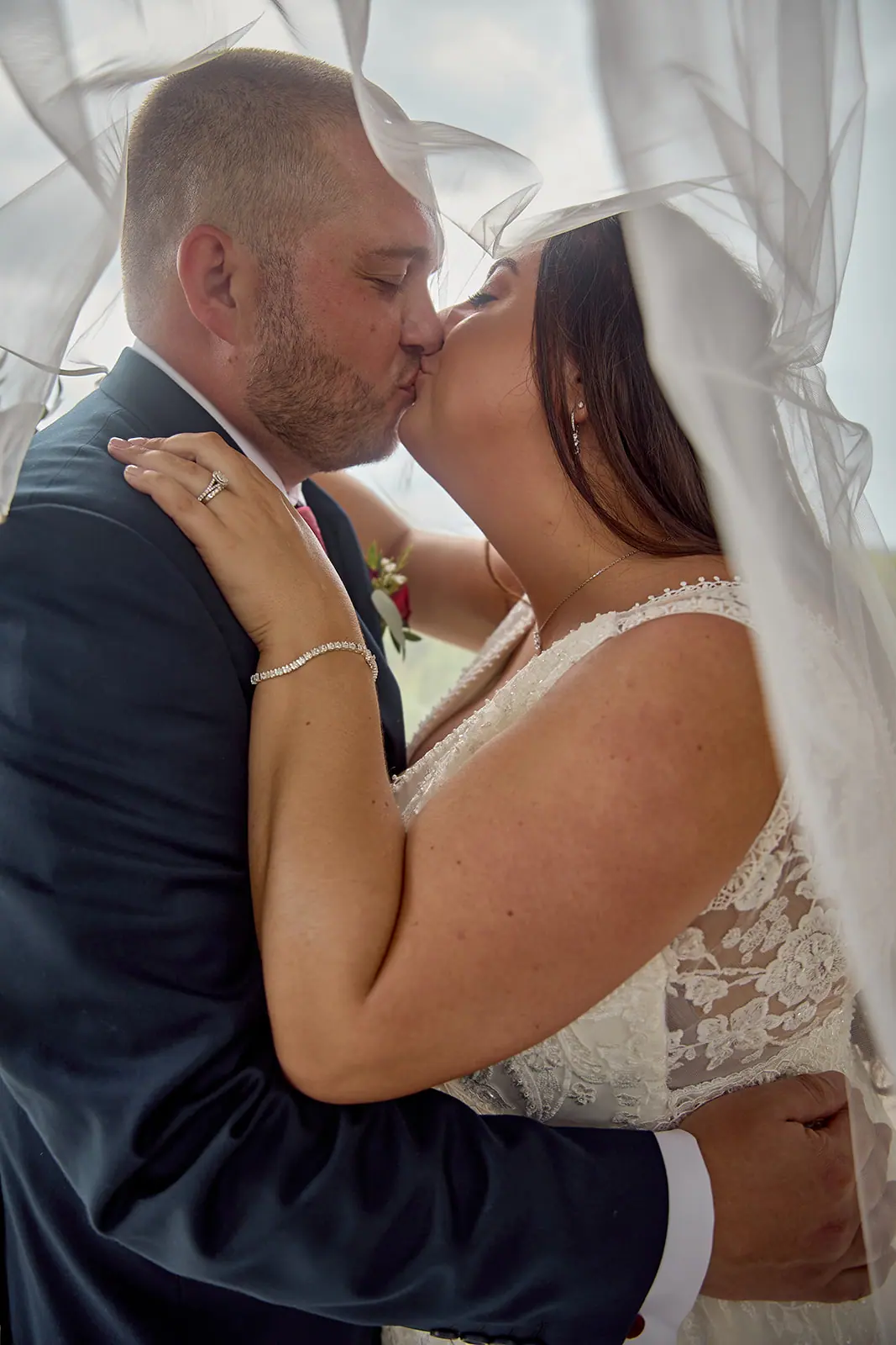 Couple kissing veil front them close — Taylor & Mark's wedding at The Manor at Fire Tower Hill, Lewiston, MI