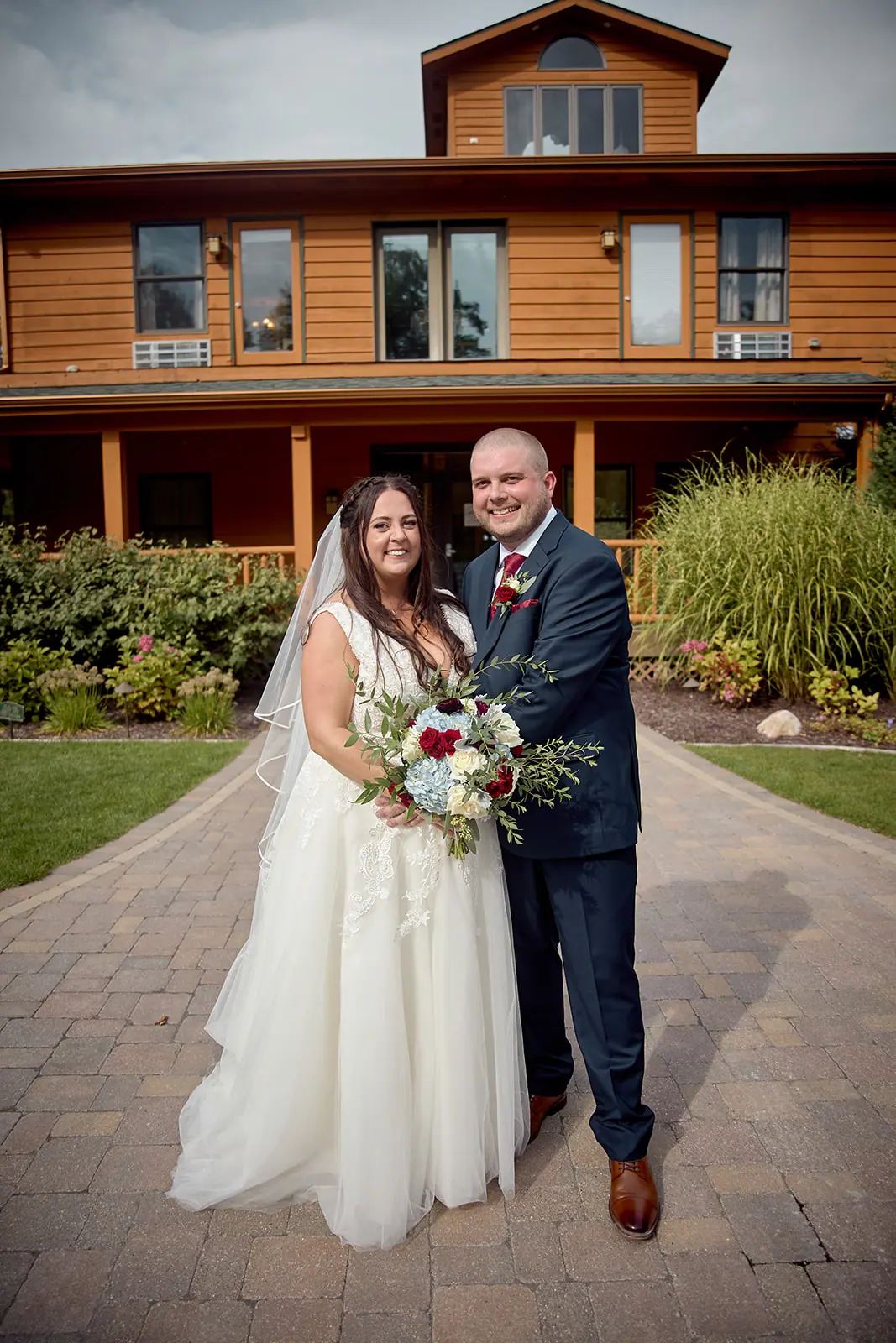 Couple standing walk front wood brick — Taylor & Mark's wedding at The Manor at Fire Tower Hill, Lewiston, MI