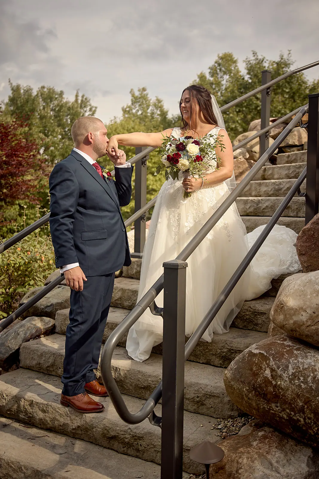Couple stone steps railing bride holding — Taylor & Mark's wedding at The Manor at Fire Tower Hill, Lewiston, MI