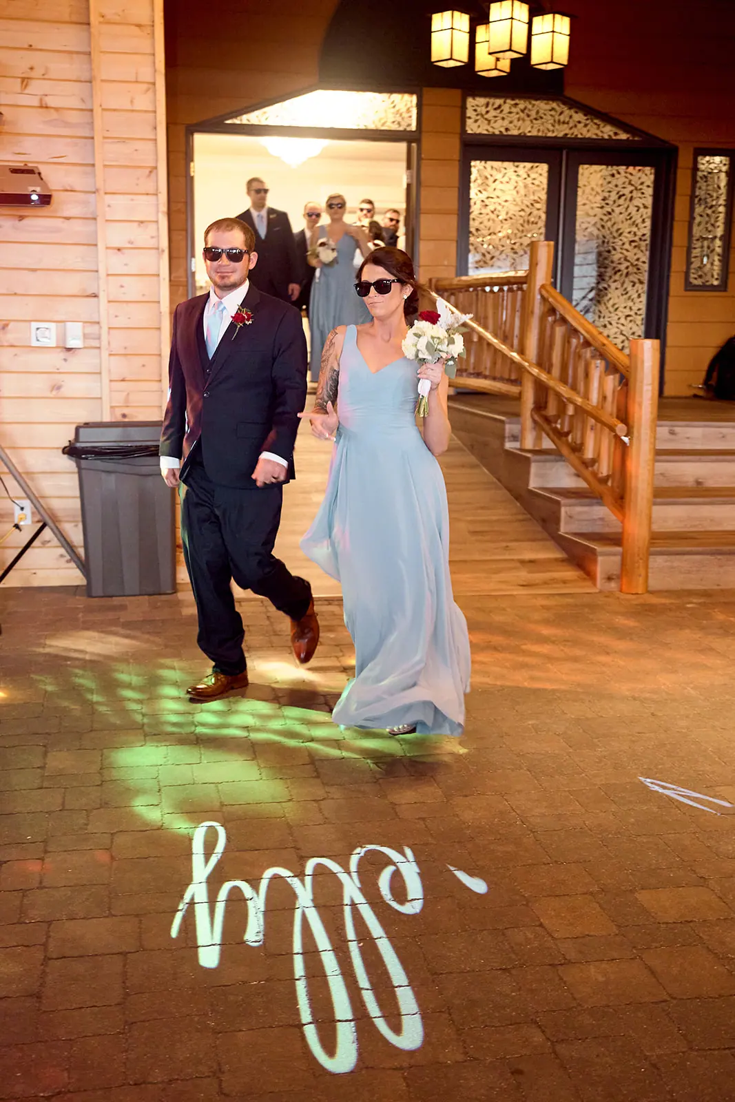 Couple walking reception projected name floor — Taylor & Mark's wedding at The Manor at Fire Tower Hill, Lewiston, MI