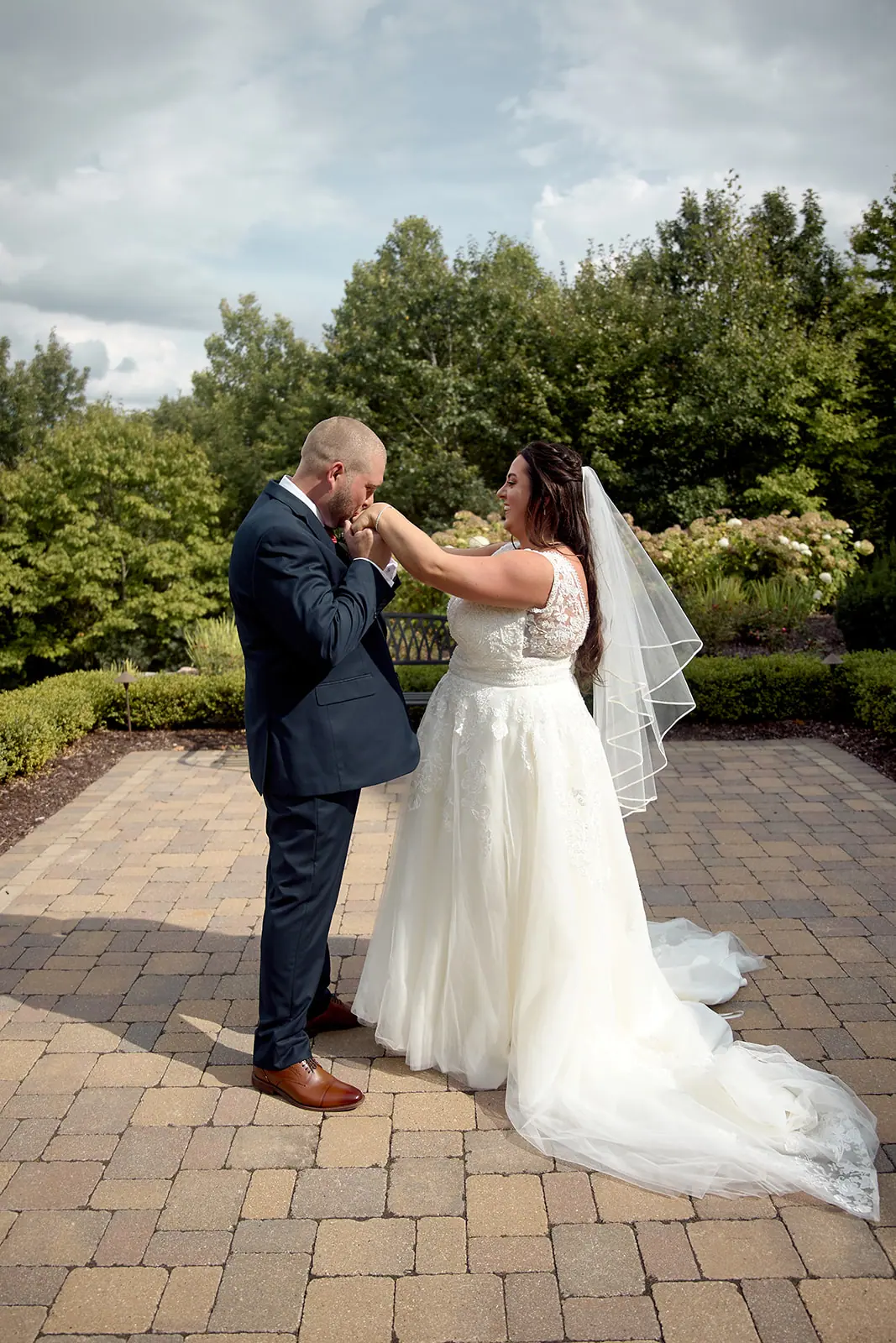 Groom kissing bride s hand patio — Taylor & Mark's wedding at The Manor at Fire Tower Hill, Lewiston, MI