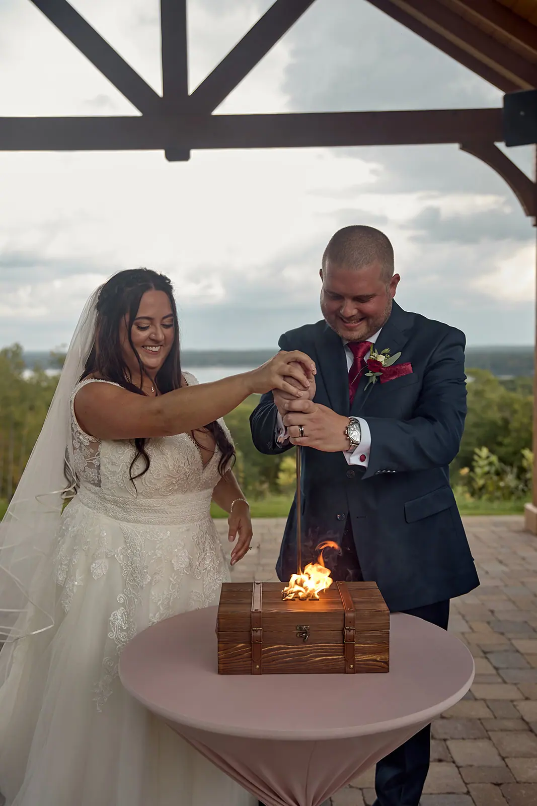 Groom lighting flame inside wooden box — Taylor & Mark's wedding at The Manor at Fire Tower Hill, Lewiston, MI