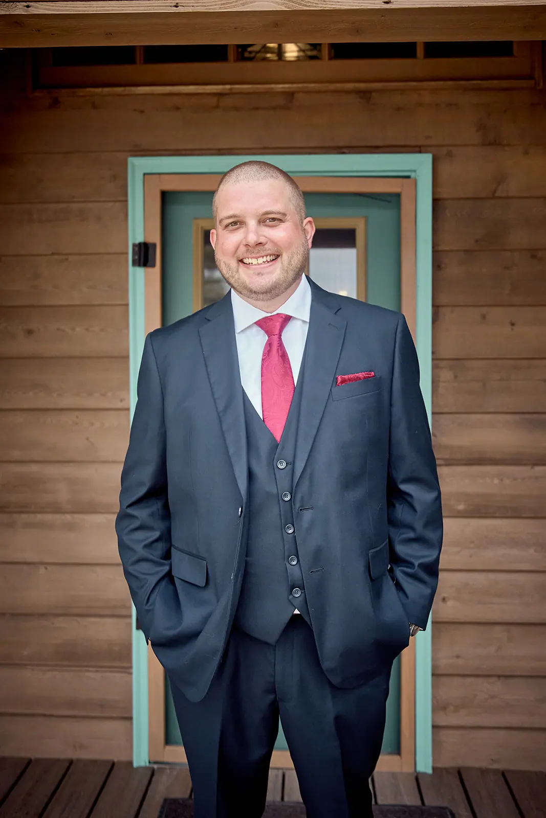 Groom navy suit hands pockets teal — Taylor & Mark's wedding at The Manor at Fire Tower Hill, Lewiston, MI